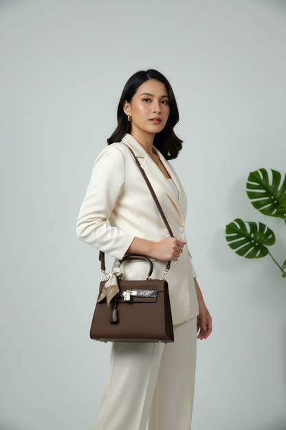 Chrisbella dark brown luxury handbag with gold lock hardware and decorative scarf for women in UAE